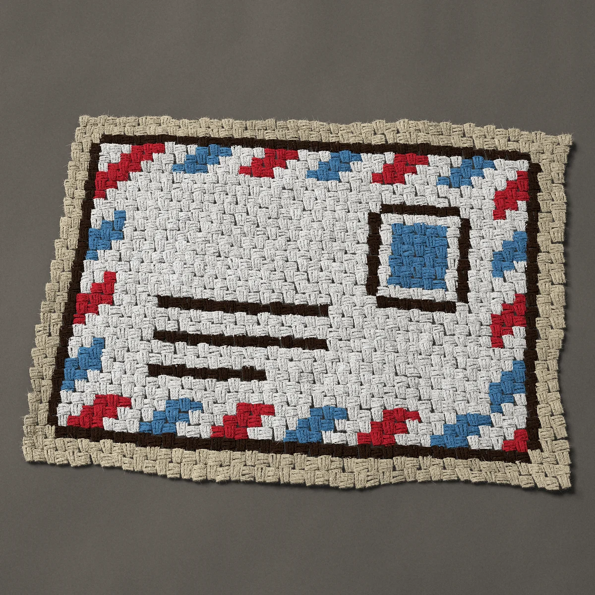 A panel worked corner to corner, 33¾ by 24¾ inches: Airmail envelope with red and blue striped edges, 45 by 33 blocks