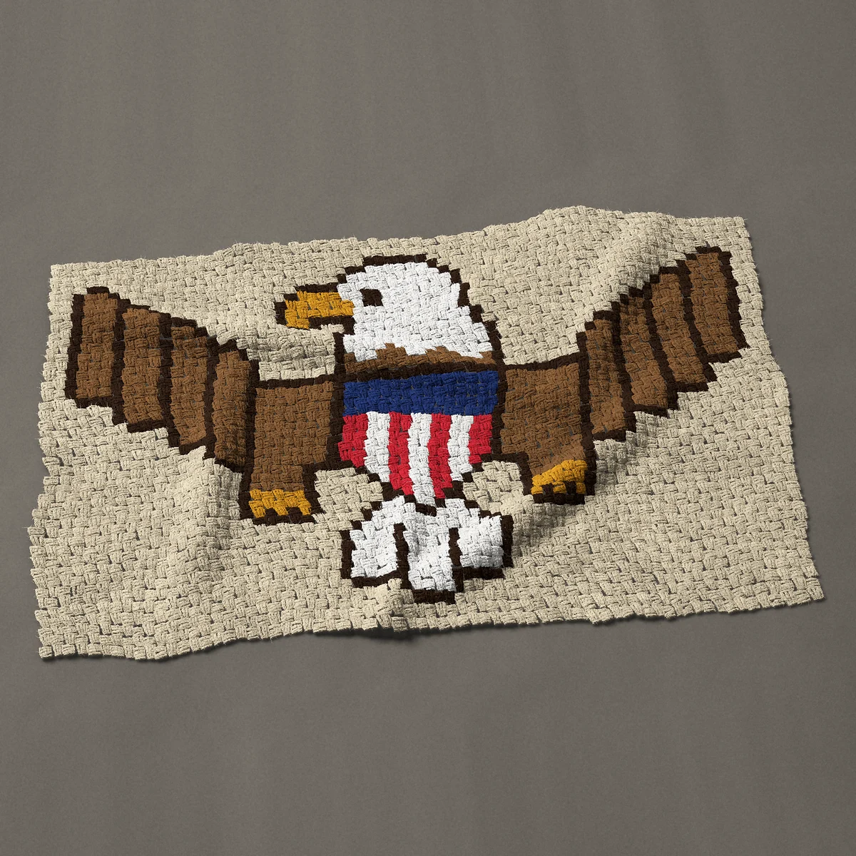 A baby blanket worked corner to corner, 51 by 33¾ inches: American bald eagle with a red, white and blue shield, 68 by 45 blocks