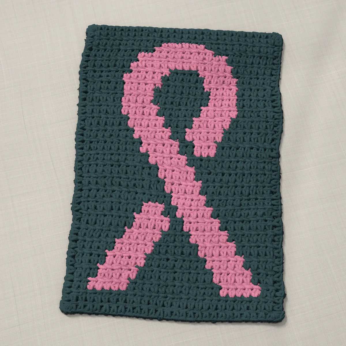 A panel in single crochet, 8 by 12 inches: an awareness ribbon in pink on a slate gray ground, 26 stitches by 45 rows