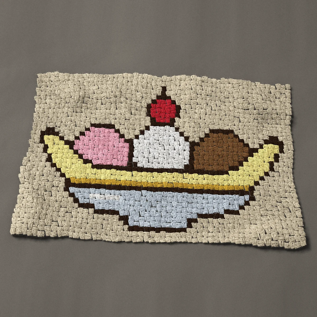 A baby blanket worked corner to corner, 39½ by 26¼ inches: Banana split with three ice cream scoops and a cherry, 53 by 35 blocks