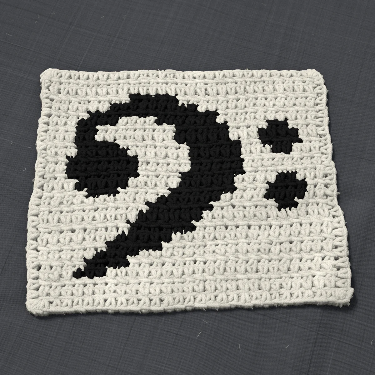 A dishcloth in single crochet, 8.3 by 6.9 inches: a bass clef in black on a cream ground, 27 stitches by 26 rows