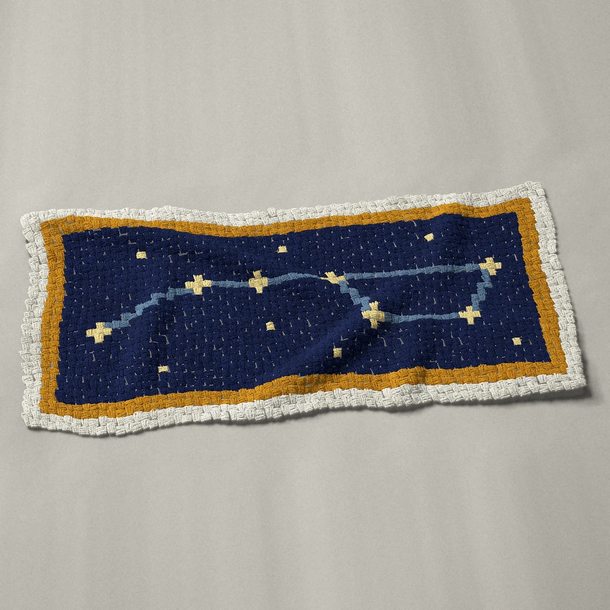 A panel worked corner to corner, 50 by 24 inches: Big Dipper constellation star chart in navy and gold, 67 by 32 blocks