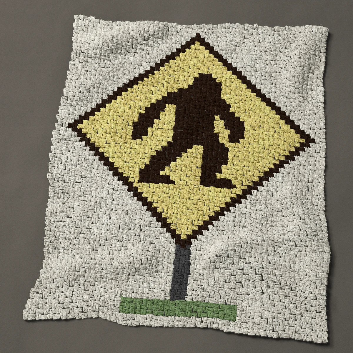 A baby blanket worked corner to corner, 39½ by 49½ inches: Sasquatch crossing sign: Bigfoot on a yellow road sign, 53 by 66 blocks