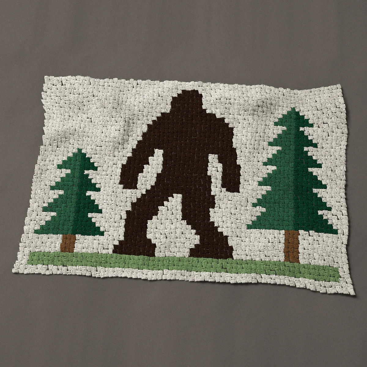 A baby blanket worked corner to corner, 51 by 35¼ inches: Bigfoot silhouette: Sasquatch walking between two pines, 68 by 47 blocks