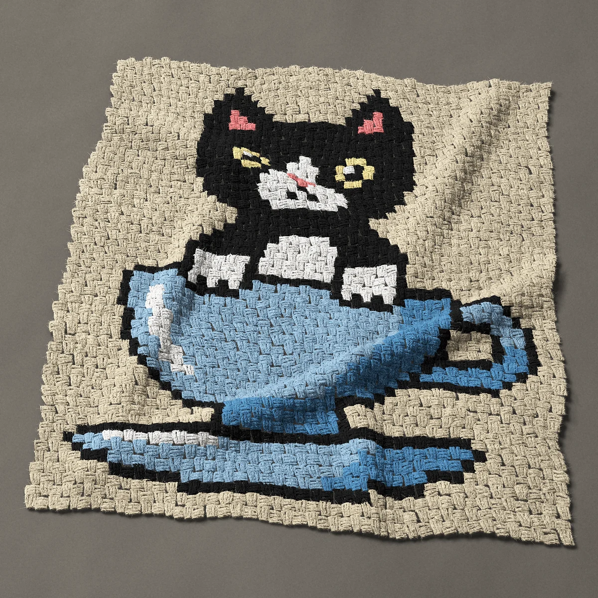 A baby blanket worked corner to corner, 35¼ by 40½ inches: Black and white tuxedo kitten in a blue teacup, 47 by 54 blocks