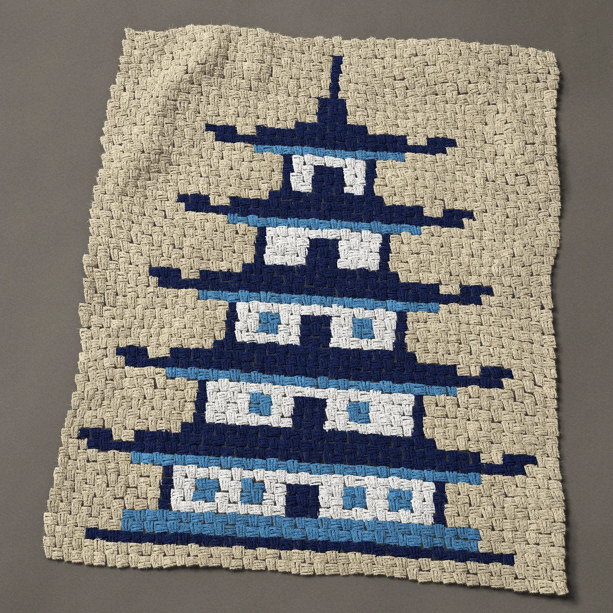 A baby blanket worked corner to corner, 33¾ by 41 inches: Blue pagoda: five-tier pagoda in blue and white, 45 by 55 blocks
