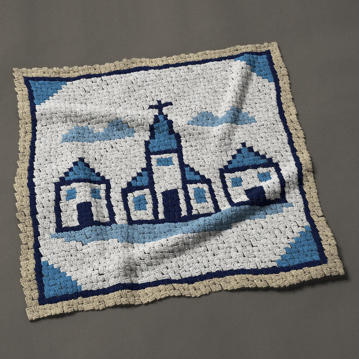A baby blanket worked corner to corner, 41 by 41 inches: Blue and white Delft style village tile with a church, 55 by 55 blocks