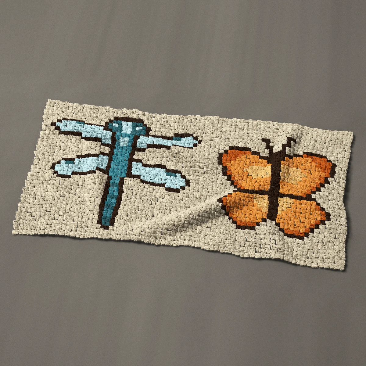 A baby blanket worked corner to corner, 51 by 27 inches: Blue dragonfly and orange butterfly side by side, 68 by 36 blocks