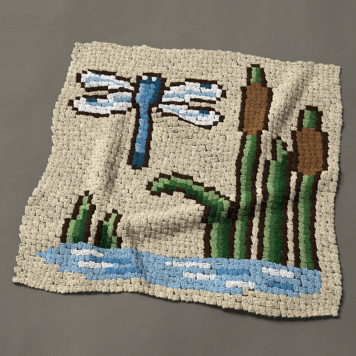 A baby blanket worked corner to corner, 40½ by 42 inches: Blue dragonfly over a pond with cattails, 54 by 56 blocks