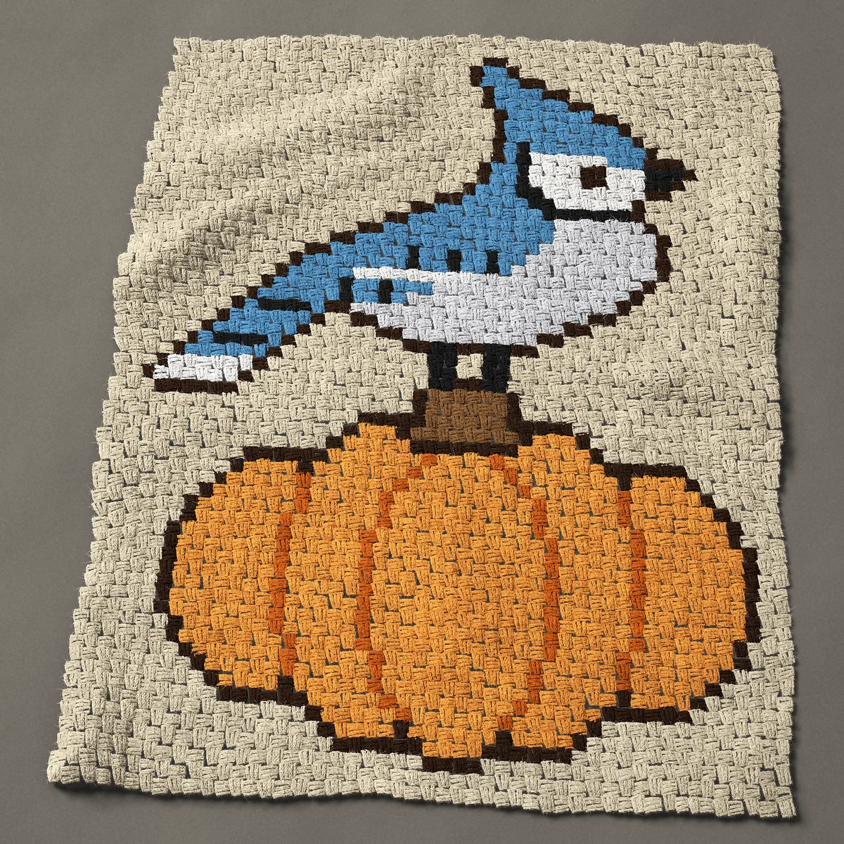 A lap blanket worked corner to corner, 36¾ by 46½ inches: Blue jay standing on a big orange pumpkin, 49 by 62 blocks