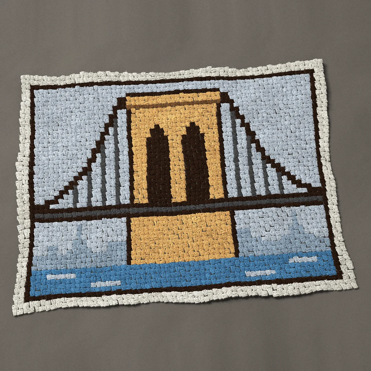 A baby blanket worked corner to corner, 50 by 39 inches: Brooklyn Bridge, New York: stone tower with two arches, 67 by 52 blocks