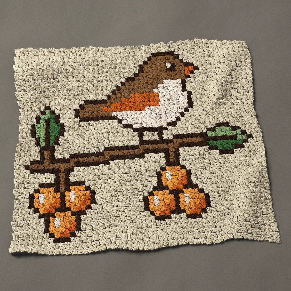 A baby blanket worked corner to corner, 37½ by 33¾ inches: Brown bird on a branch with orange berries, 50 by 45 blocks