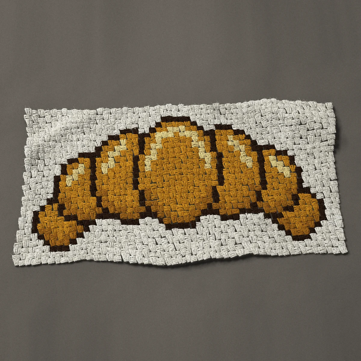 A panel worked corner to corner, 38 by 20¼ inches: Croissant: a golden butter croissant, 51 by 27 blocks