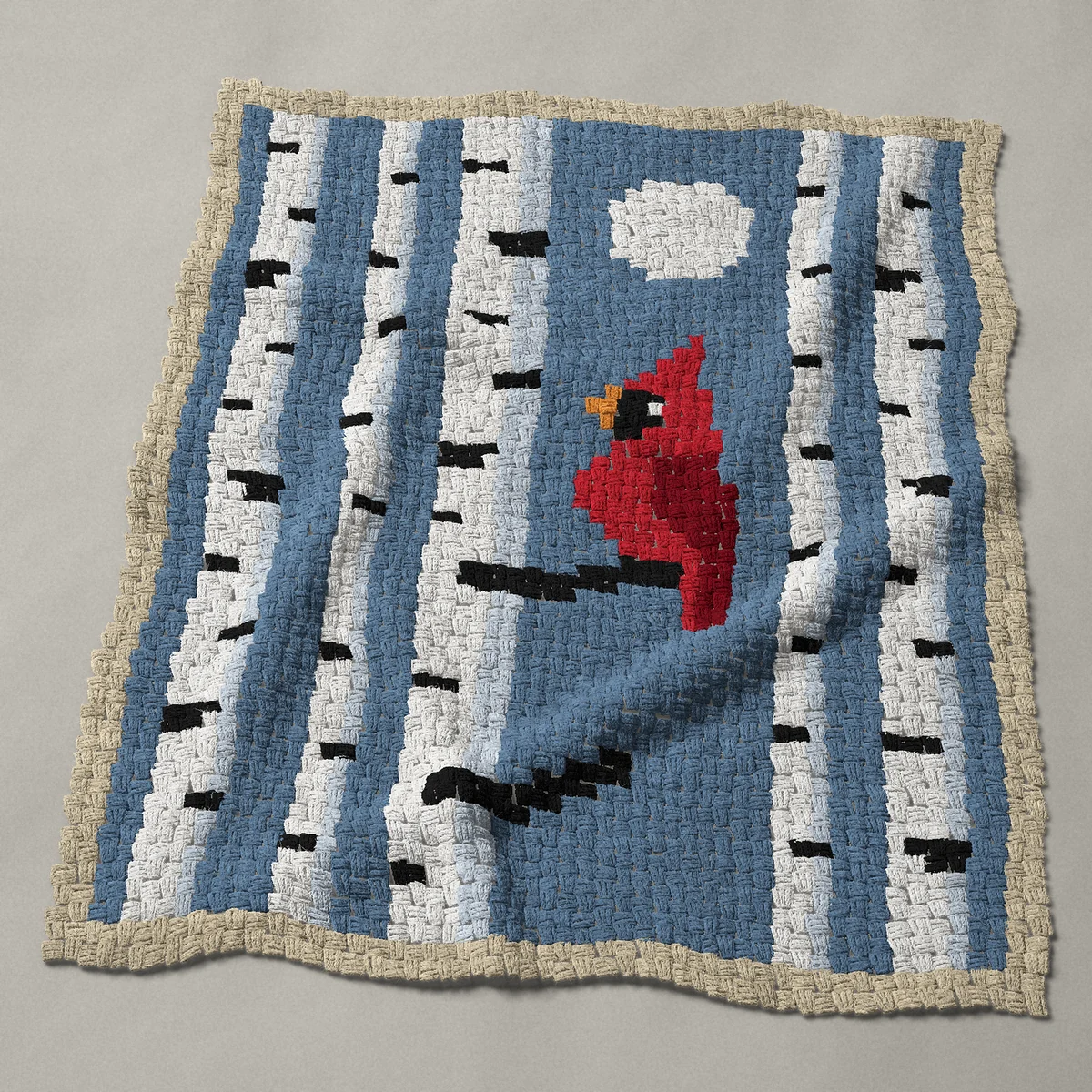 A baby blanket worked corner to corner, 40½ by 49½ inches: Cardinal in birch trees with a full moon, 54 by 66 blocks