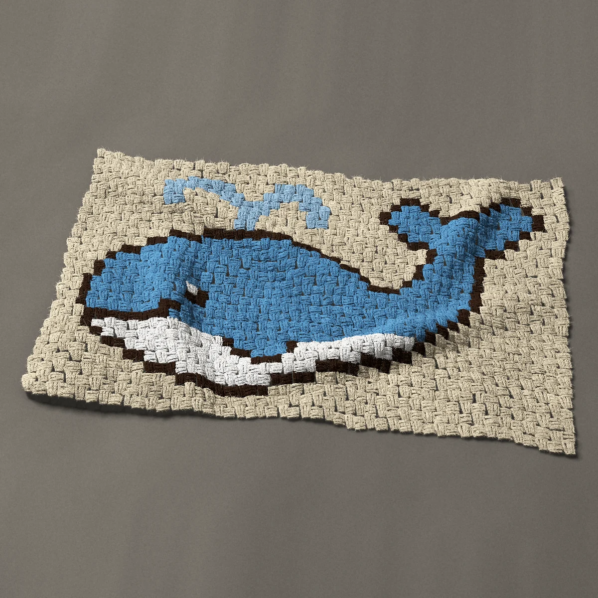 A panel worked corner to corner, 35¼ by 21¾ inches: Cartoon whale spouting water, blue with a white belly, 47 by 29 blocks