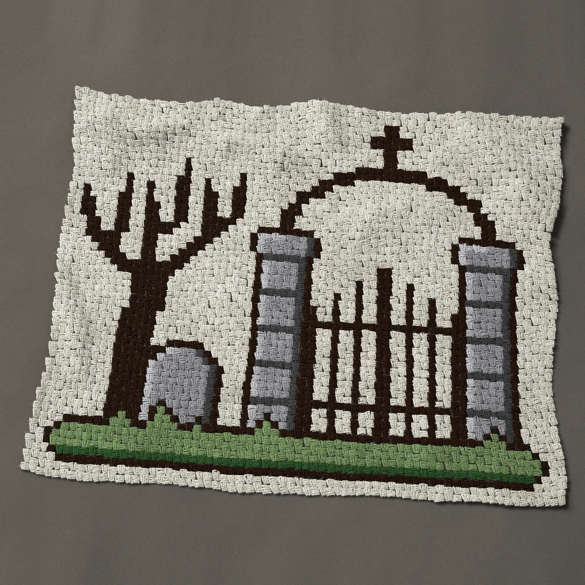 A baby blanket worked corner to corner, 51 by 41 inches: Cemetery gate with iron arch, bare tree and tombstone, 68 by 55 blocks