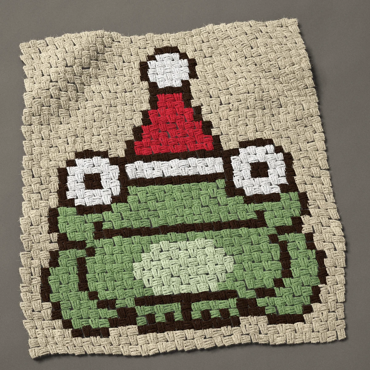 A panel worked corner to corner, 26¼ by 30 inches: Christmas frog in a Santa hat, 35 by 40 blocks
