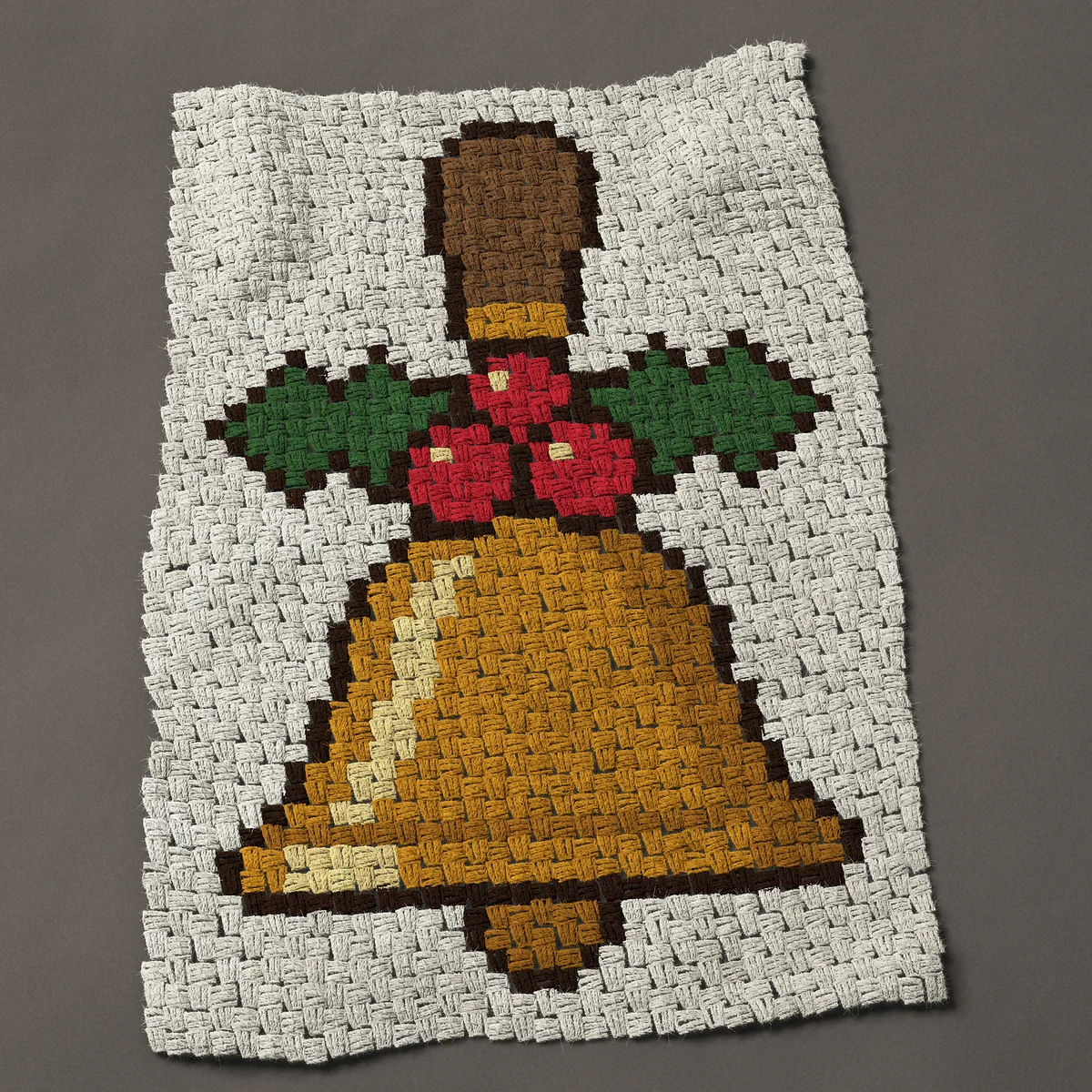 A baby blanket worked corner to corner, 26¼ by 37½ inches: Christmas hand bell with a wooden handle and holly, 35 by 50 blocks