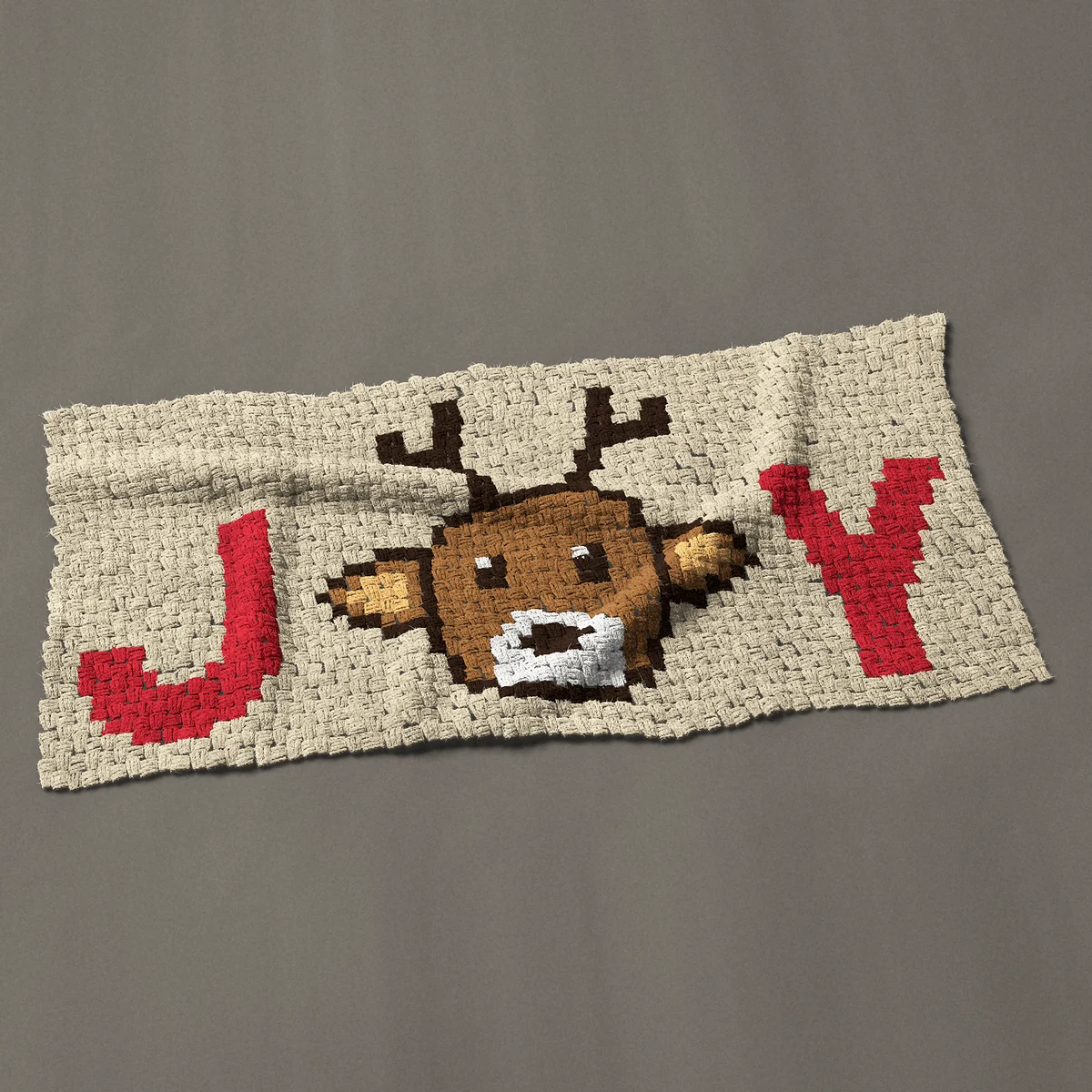 A panel worked corner to corner, 48½ by 23¼ inches: Christmas Joy lettering with a reindeer face for the O, 65 by 31 blocks