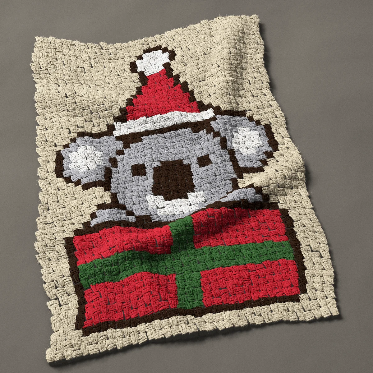 A baby blanket worked corner to corner, 26¼ by 39½ inches: Christmas koala in a Santa hat in a gift box, 35 by 53 blocks