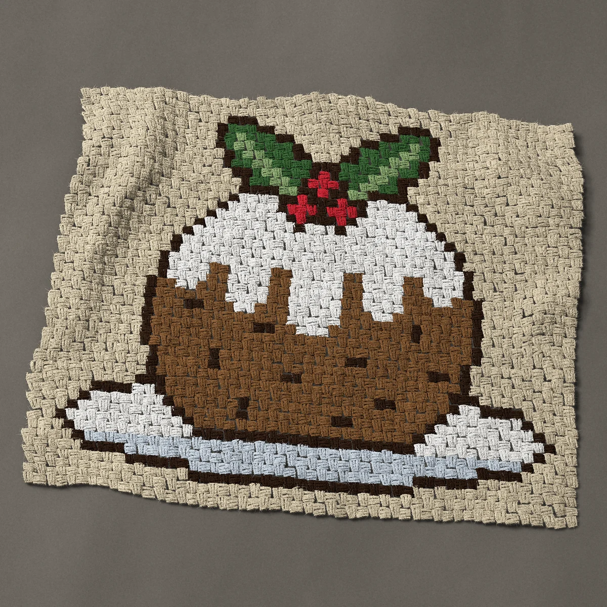 A baby blanket worked corner to corner, 38 by 32¼ inches: Christmas pudding with white icing and holly on a plate, 51 by 43 blocks