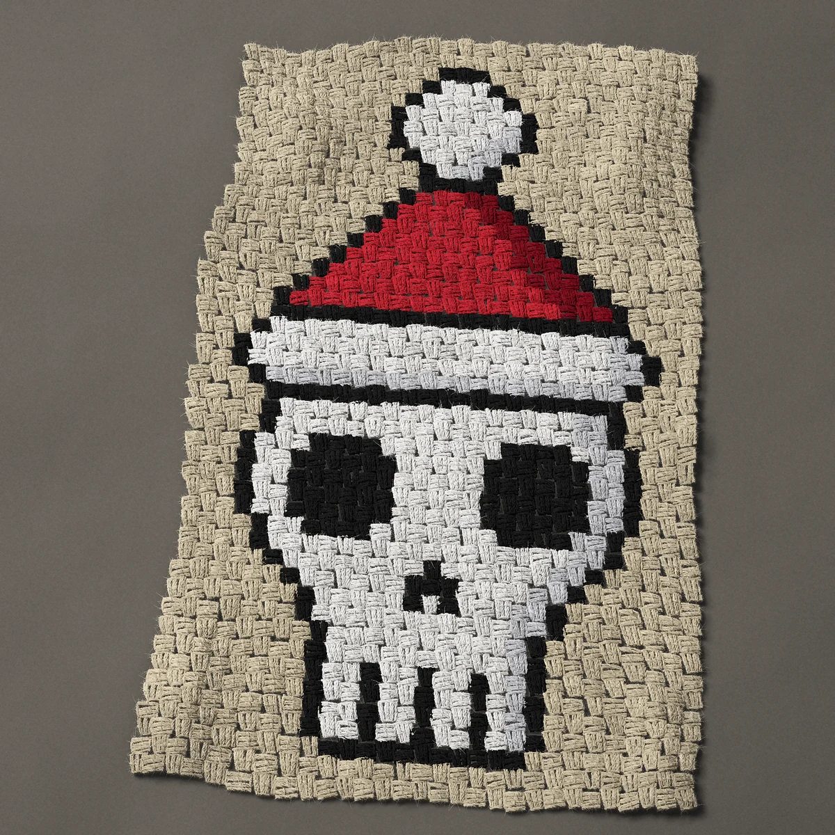 A panel worked corner to corner, 21¾ by 35¼ inches: Christmas skull wearing a Santa hat, 29 by 47 blocks