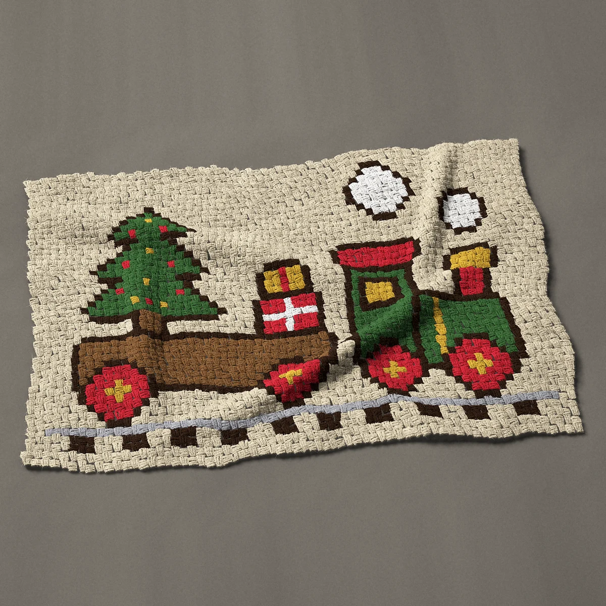 A baby blanket worked corner to corner, 50 by 33¾ inches: Christmas train with tree and presents, 67 by 45 blocks
