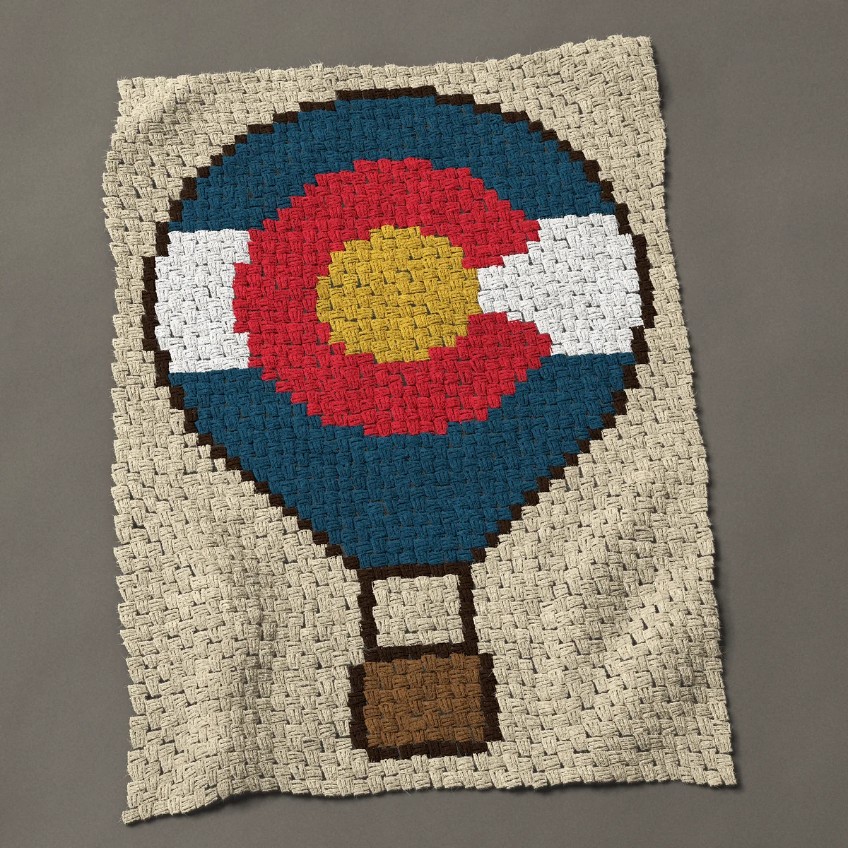 A baby blanket worked corner to corner, 31½ by 44 inches: Colorado flag hot air balloon with a brown basket, 42 by 59 blocks