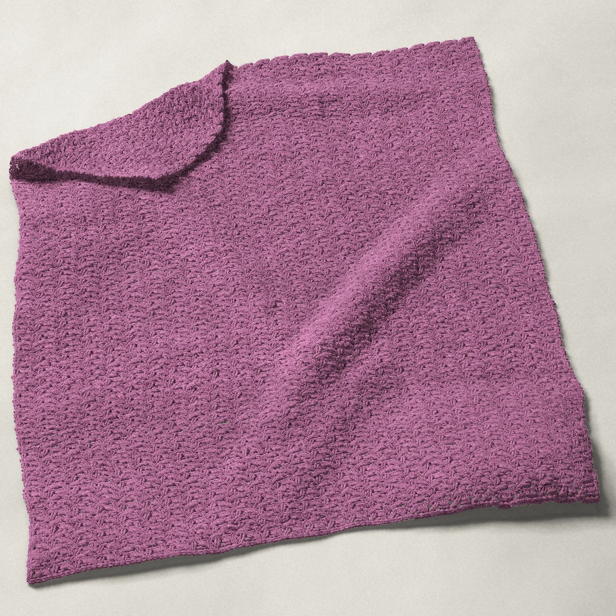 A baby blanket in crazy stitch, 32½ by 40 inches, spread out with a corner turned over