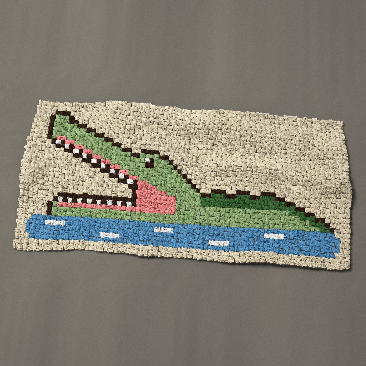 A baby blanket worked corner to corner, 50 by 24¾ inches: Crocodile with its jaws wide open in the river, 67 by 33 blocks