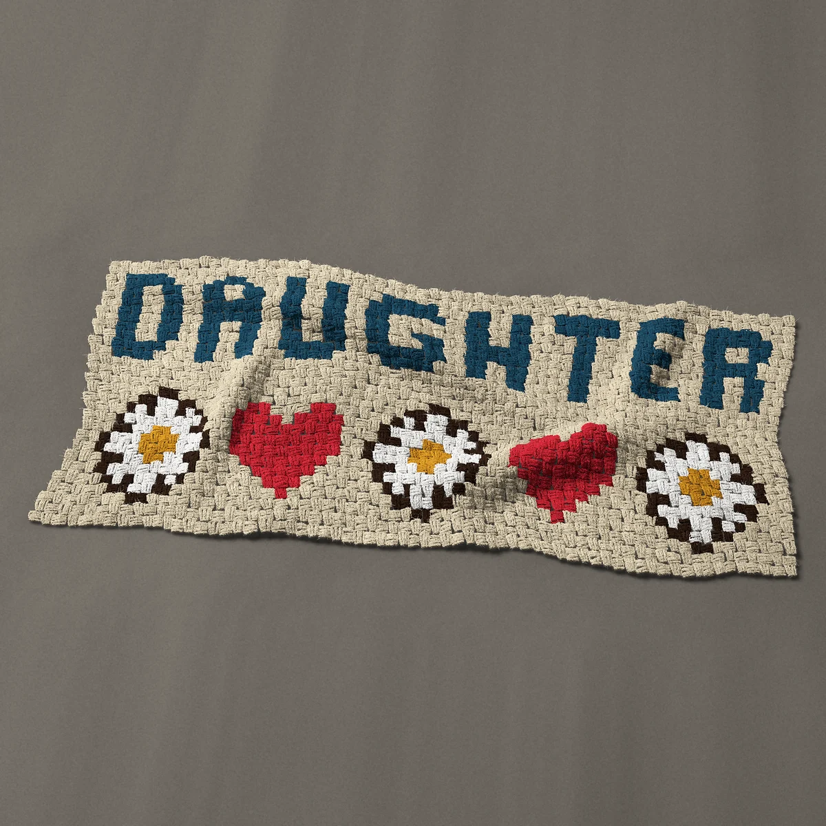 A panel worked corner to corner, 49½ by 21¾ inches: DAUGHTER in navy blue capitals with daisies and hearts, 66 by 29 blocks