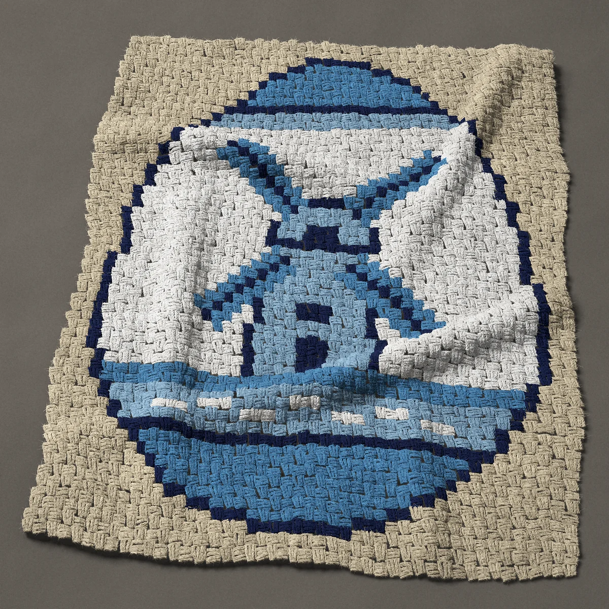 A baby blanket worked corner to corner, 33¾ by 43½ inches: Delft blue Easter egg with a windmill, 45 by 58 blocks