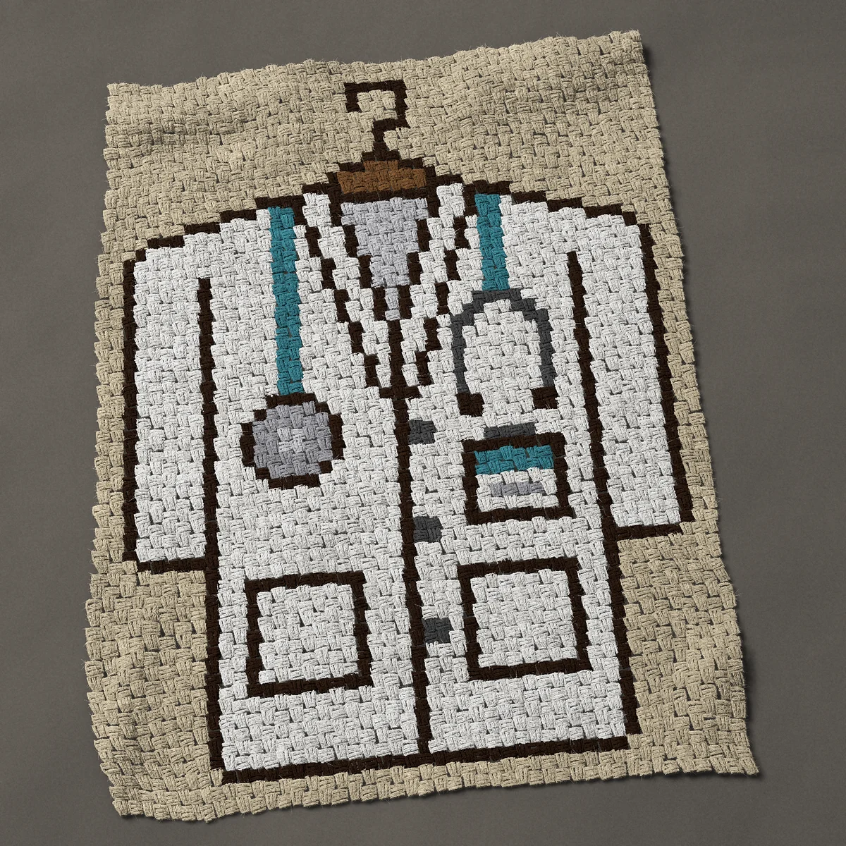 A lap blanket worked corner to corner, 35¼ by 47 inches: Medical doctor white coat on a hanger with stethoscope, 47 by 63 blocks