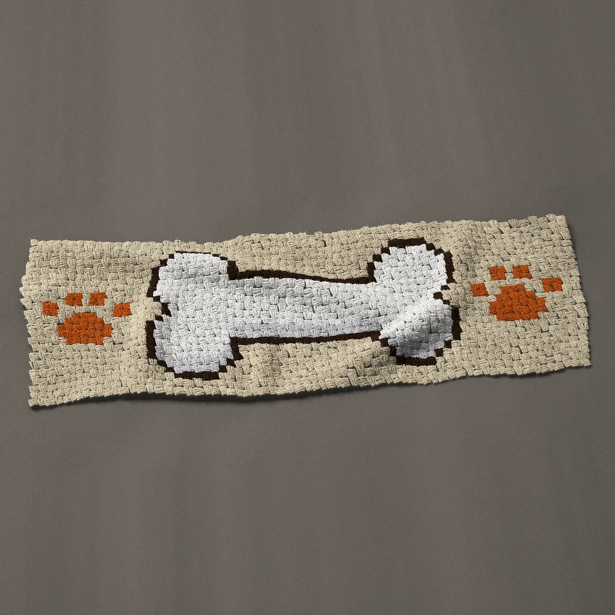 A panel worked corner to corner, 51 by 18 inches: Dog bone with paw prints, blank for a name, 68 by 24 blocks