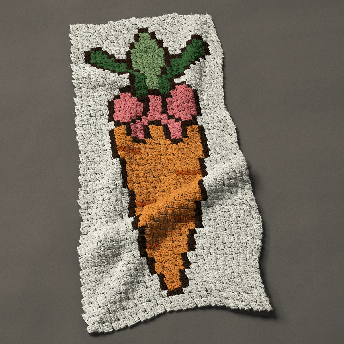 A panel worked corner to corner, 19½ by 44 inches: Easter carrot with a leafy top and a pink bow, 26 by 59 blocks