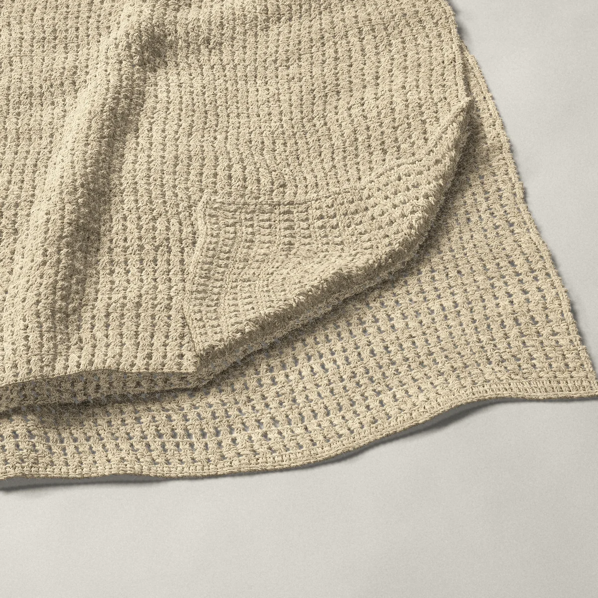 A throw in crossed double crochet in every row, 54¼ by 66¼ inches, folded in half with a corner turned back