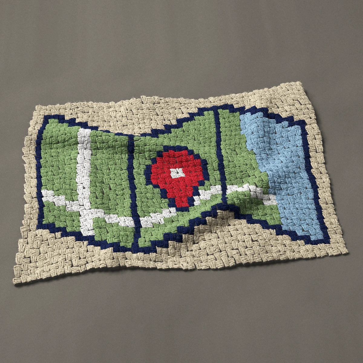 A baby blanket worked corner to corner, 37½ by 25½ inches: Folded travel map with roads and a red location pin, 50 by 34 blocks