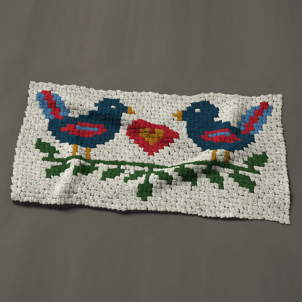 A baby blanket worked corner to corner, 44 by 24¾ inches: Two folk art love birds with a heart, 59 by 33 blocks