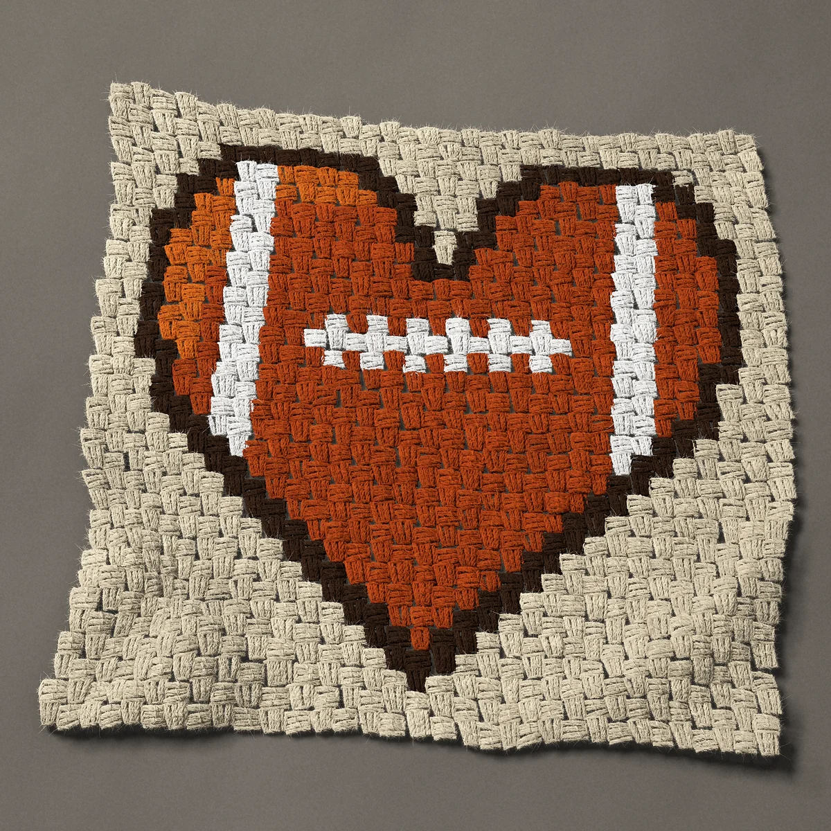 A panel worked corner to corner, 24¾ by 24 inches: Football heart with white laces, 33 by 32 blocks