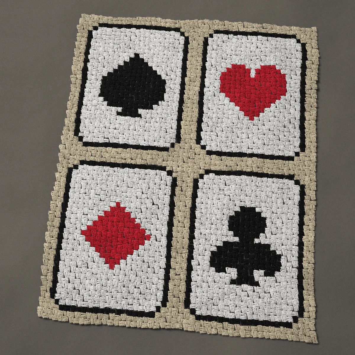 A lap blanket worked corner to corner, 36¾ by 48½ inches: Four playing cards, one of each card suit, 49 by 65 blocks