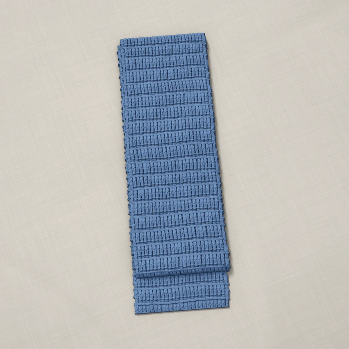 A scarf in front post double crochet rows, 7 by 60¼ inches, folded in thirds