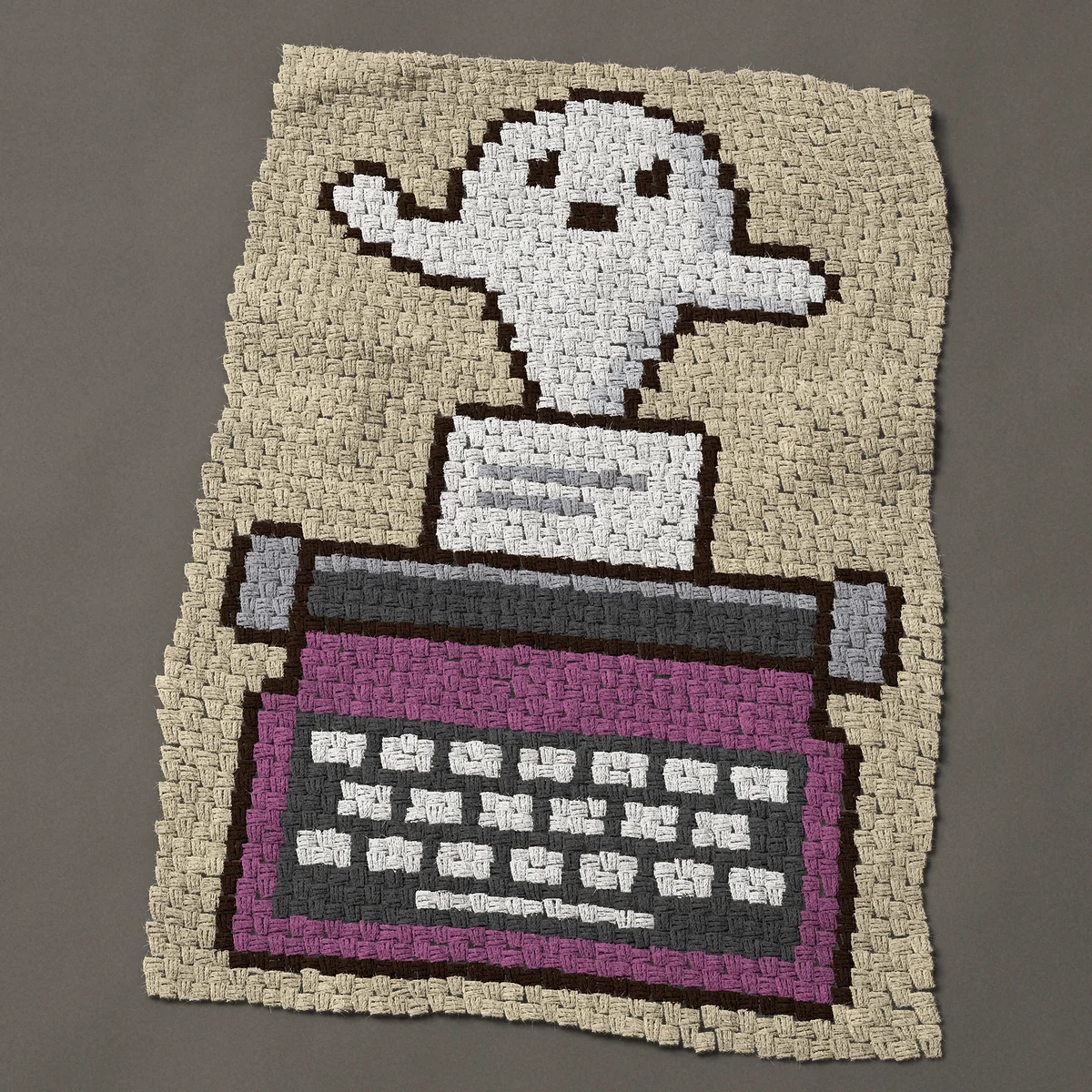 A baby blanket worked corner to corner, 32¼ by 48 inches: Ghost writer: a ghost rising from a purple typewriter, 43 by 64 blocks