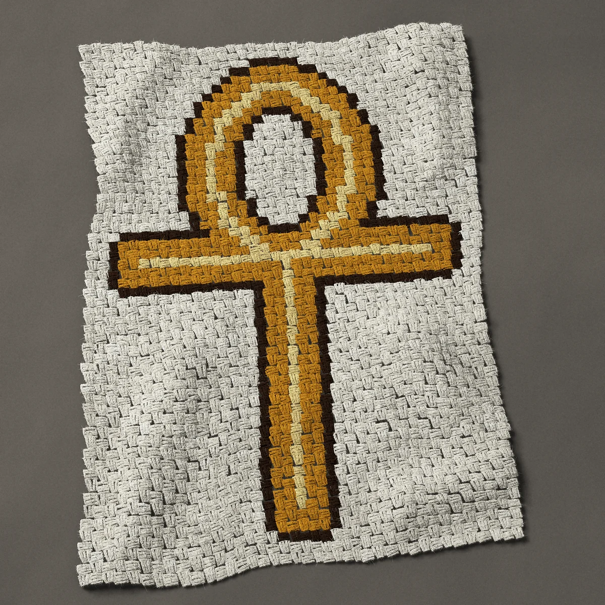 A baby blanket worked corner to corner, 29¼ by 42 inches: Gold Egyptian ankh, the key of life, 39 by 56 blocks