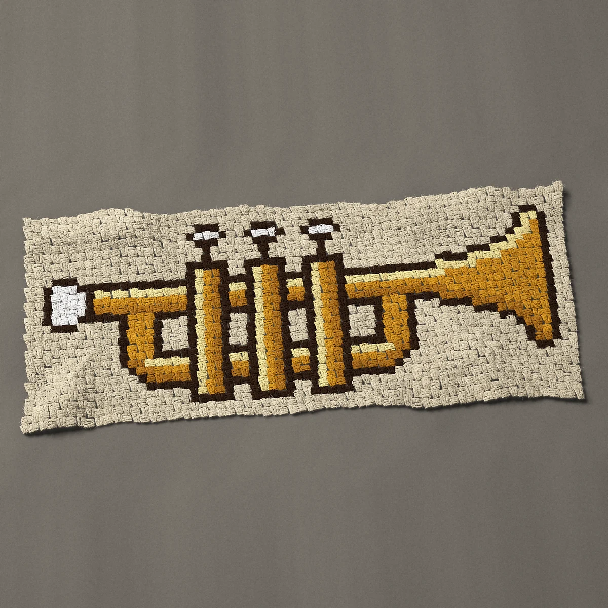 A panel worked corner to corner, 48½ by 20¼ inches: Gold trumpet with three valves, side view, 65 by 27 blocks