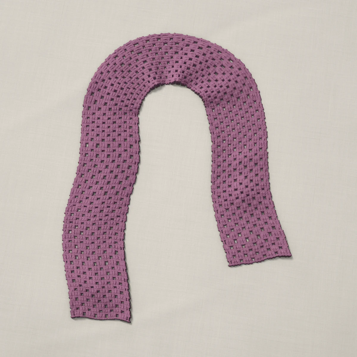 A scarf in granny groups and chains, 6.5 by 60.3 inches, lying in a loose bend