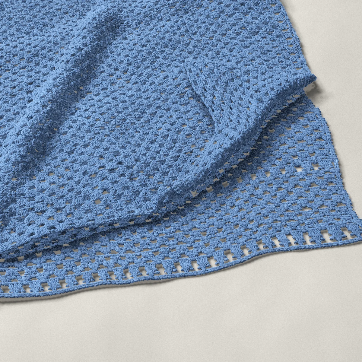 A throw in granny groups and chains, 54½ by 65½ inches, folded in half with a corner turned back