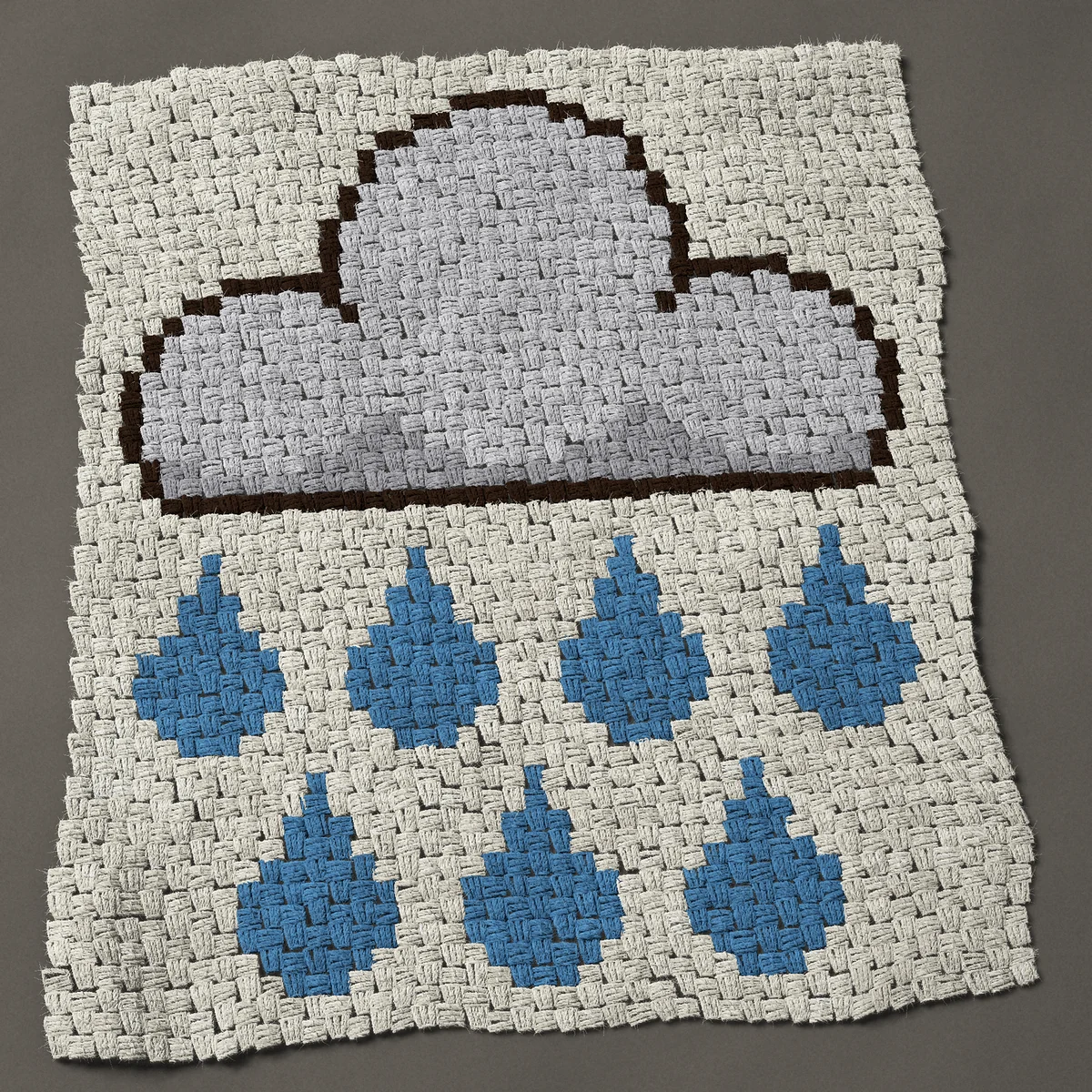 A baby blanket worked corner to corner, 32¼ by 37½ inches: Gray rain cloud with seven blue raindrops, 43 by 50 blocks
