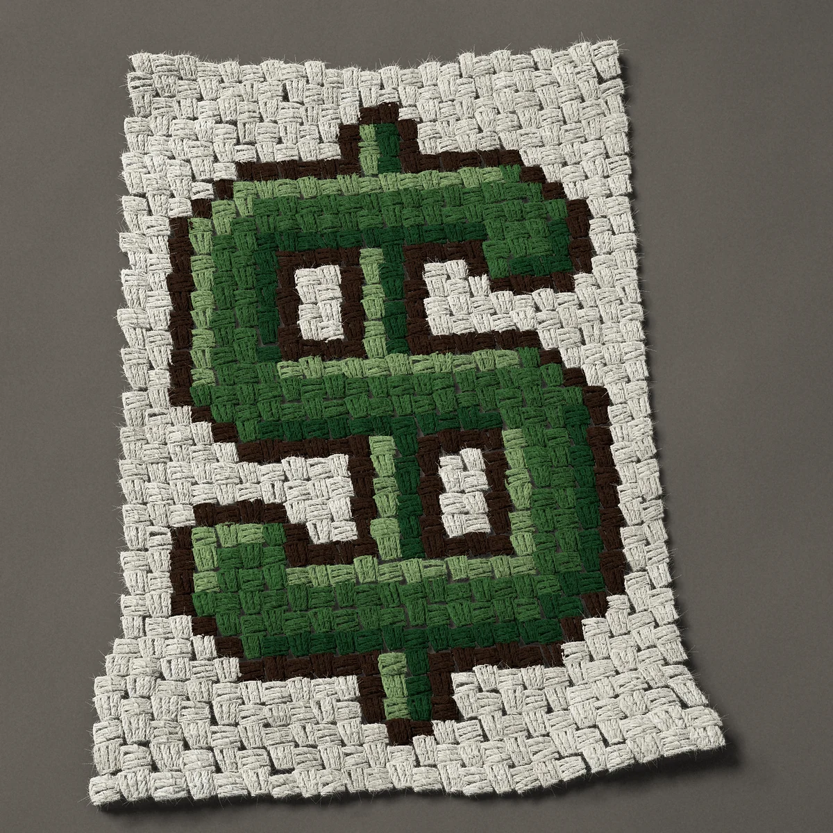 A panel worked corner to corner, 18 by 27 inches: Green dollar sign, a money symbol, 24 by 36 blocks