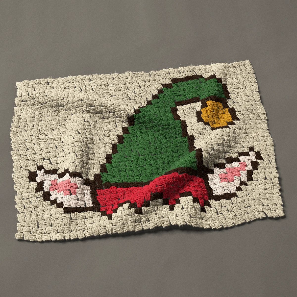 A panel worked corner to corner, 31½ by 24¾ inches: Green elf hat with pointed ears and a gold bell, 42 by 33 blocks