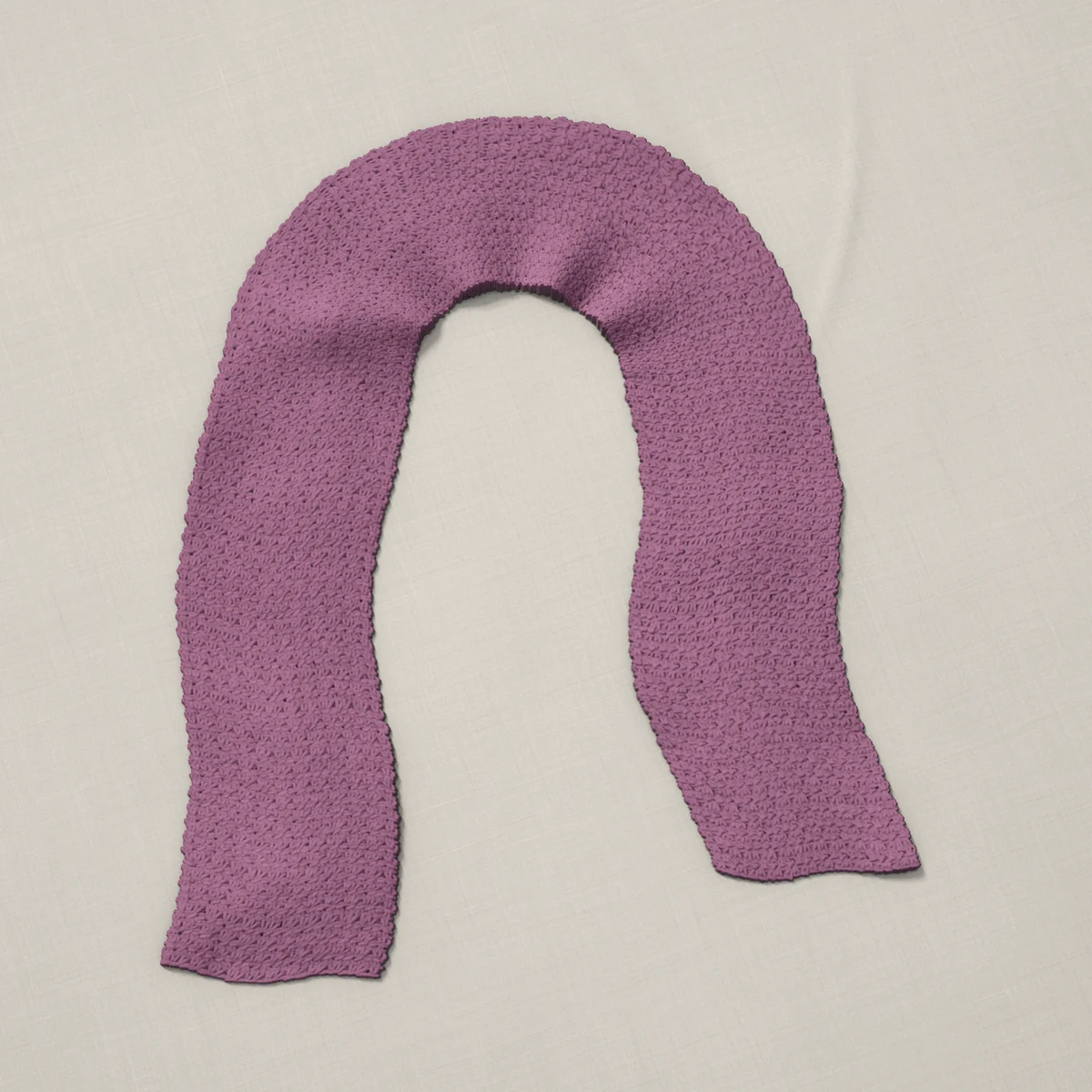 A scarf in grit stitch, 6.8 by 60 inches, lying in a loose bend